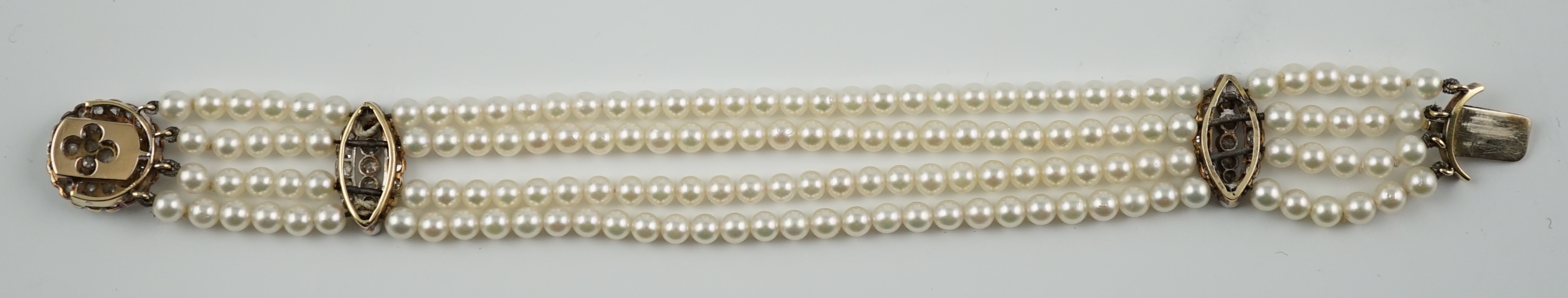 A multi-strand cultured pearl bracelet, with circular diamond cluster set gold clasp